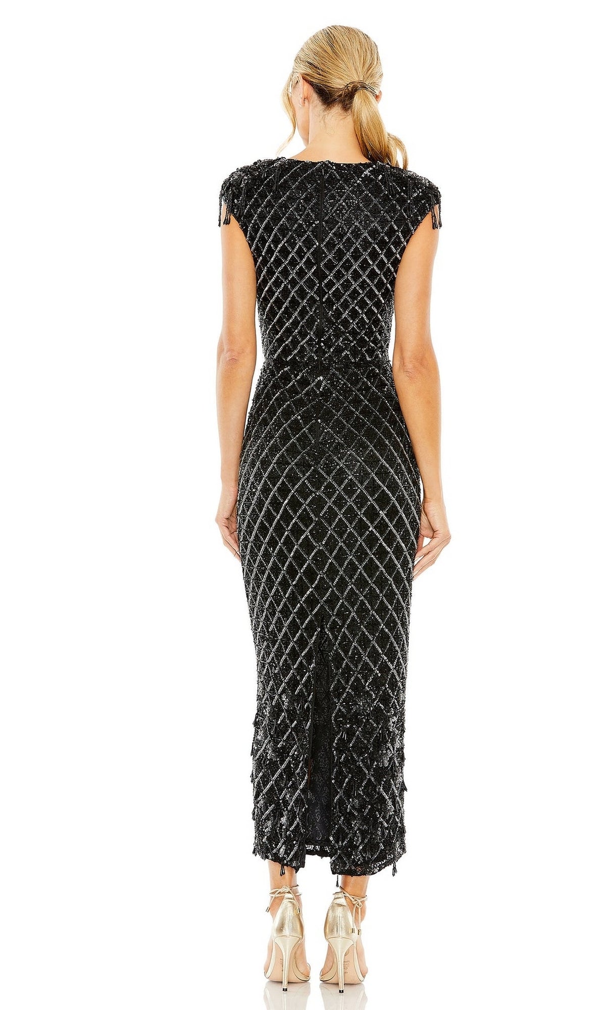A woman with blonde hair in a ponytail wears the Beaded Black Midi Formal Dress: Mac Duggal 5776 and silver high-heeled sandals, standing with her back to the camera.